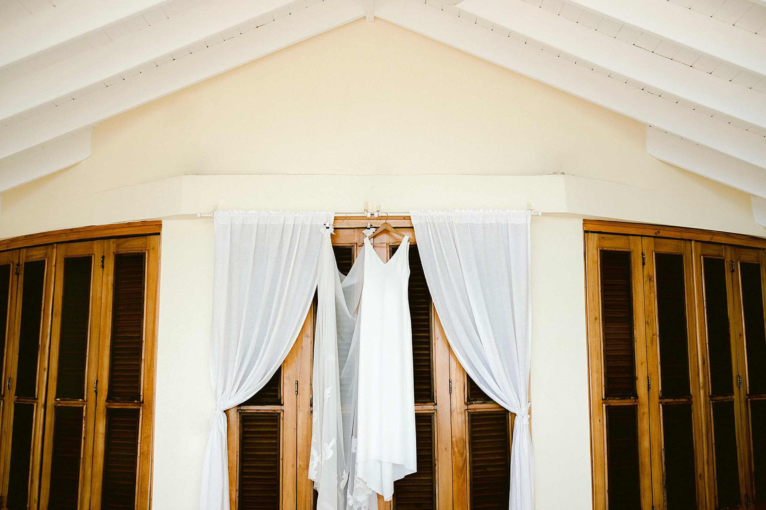 A beautiful wedding dress hanging from the balcony - The Dominican Republic wedding photographer