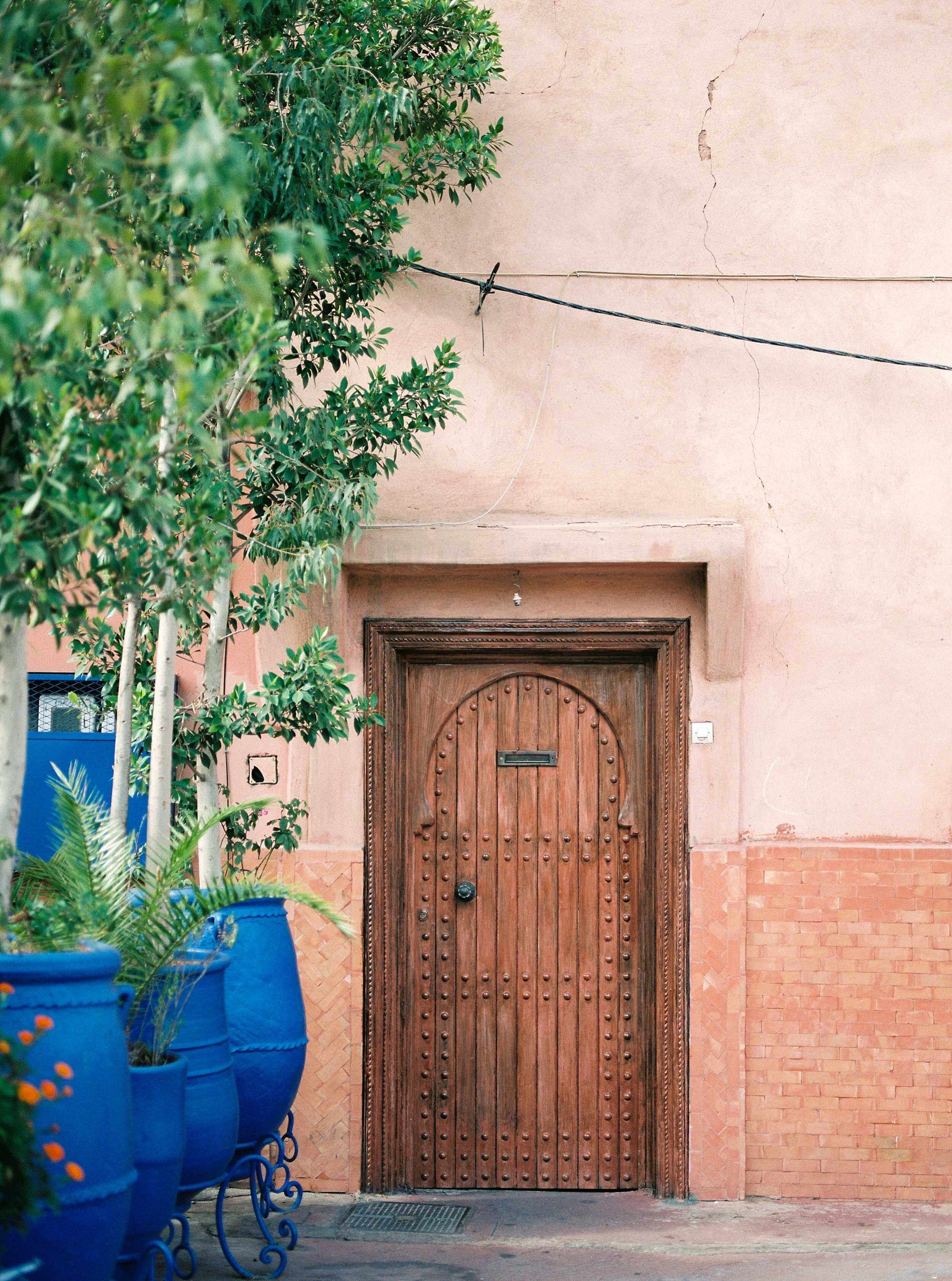 Wooden door and coral tones in the Medina of Marrakech. Wanderlust travel wall art Morocco